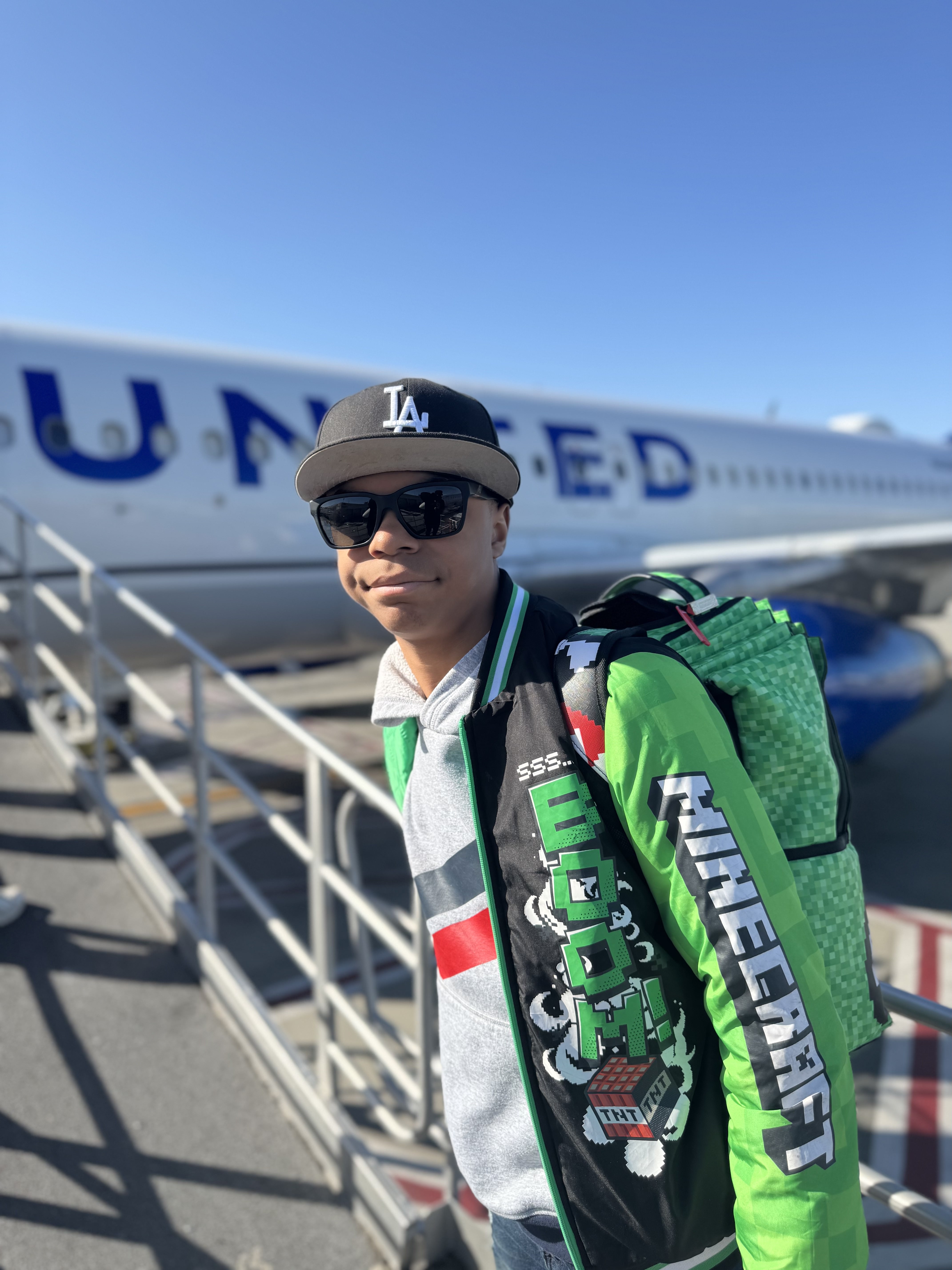 Gregory boarding a United Airlines plane during a father-son travel experience